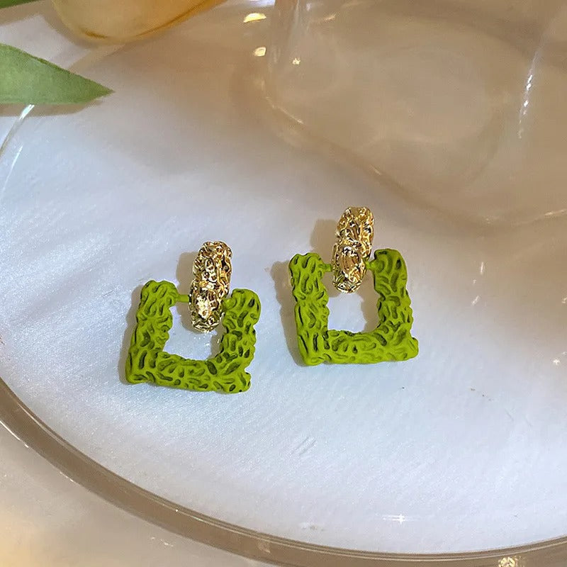 Green square studs.