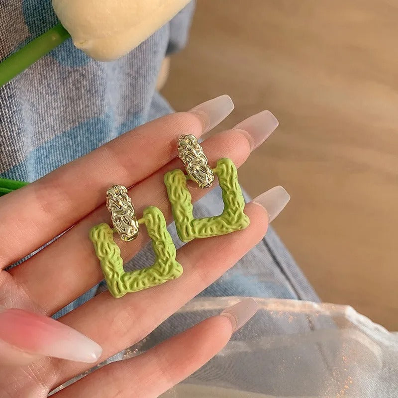 Green square studs.