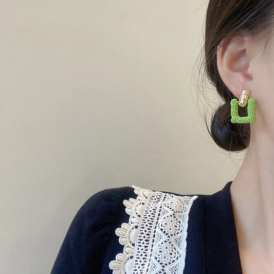 Green square studs.