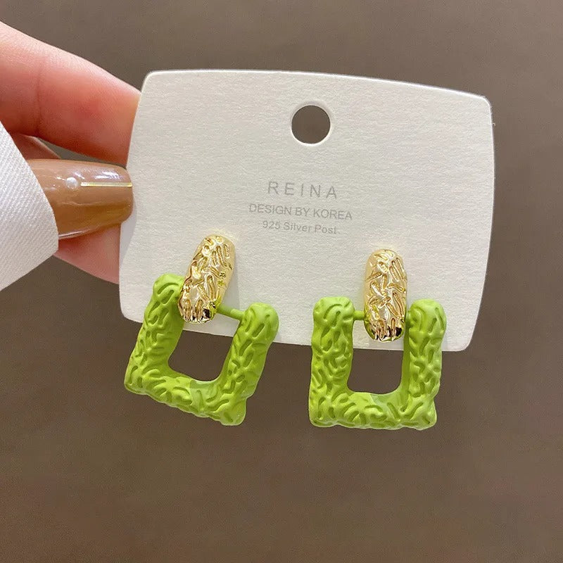 Green square studs.