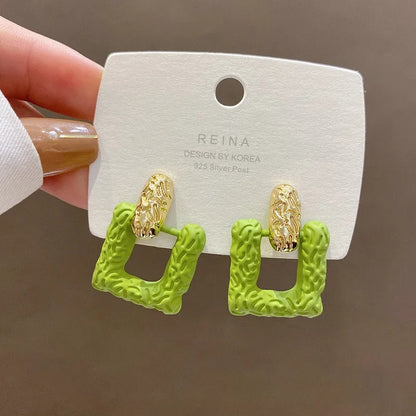 Green square studs.